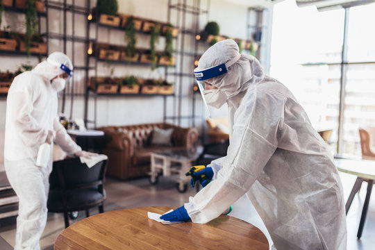 Professional Workers In Hazmat Suits Disinfecting Indoor Of Cafe Or Restaurant, Pandemic Health Risk, Coronavirus