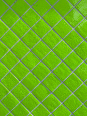 Neon green tiled wall pattern with textured glazed surface