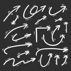 Hand drawn doodle arrows set on a blackboard background