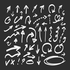 Hand drawn doodle arrows set on a blackboard background