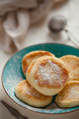 Obraz na płótnie Canvas cottage cheese pancakes with powdered sugar