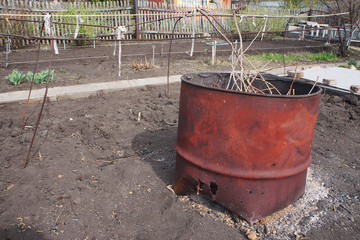 Old metal barrel in the garden.