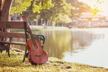 View of Acoustic guitar at lake. background the nature of the lake.