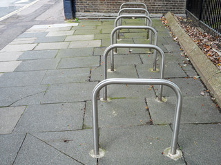 Row of empty Sheffield stand bike racks on the pavement