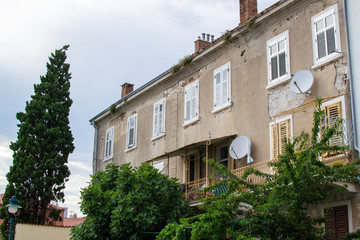 Facade of an old house in the old town of Rovinj, Croatia, with some vegetation