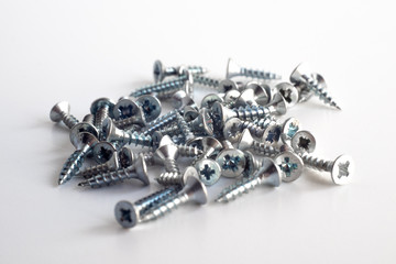 Metal screws of silver color on an isolate