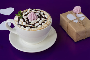Mug of hot chocolate with marshmallows on a blue background