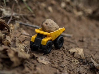 Toy construction machinery working on an excavation