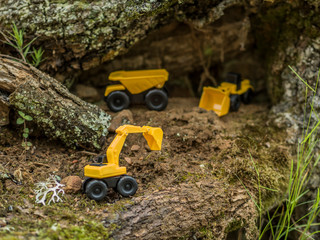 Toy construction machinery working on an excavation