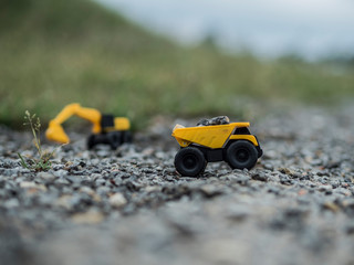 Toy construction machinery working on an excavation