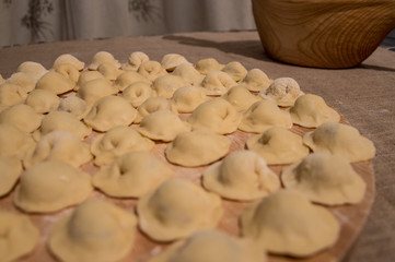 Raw Russian dumplings on a cutting Board.