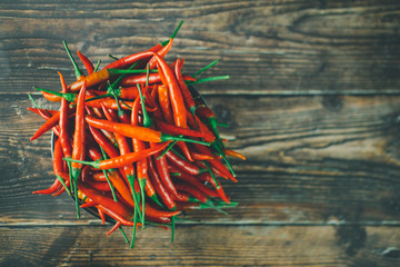 Red hot chili peppers on wooden background
