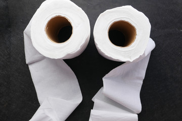 roll of toilet paper on gray background 