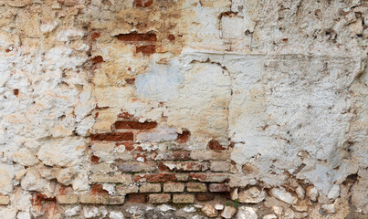 Old brick wall with damaged white lime. Textured surface for backgrounds.
