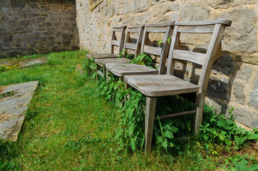 Fototapeta na wymiar 4 old wood chairs outside