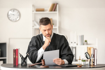Male judge working at table in office