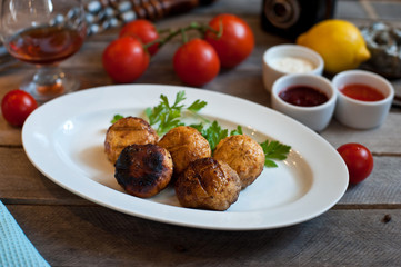 grilled mushrooms on a white plate. Wooden background