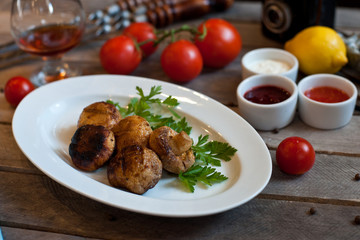 grilled mushrooms on a white plate. Wooden background