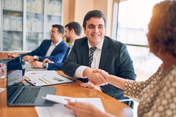 Business lawyers workers meeting at law firm office. Professional executive partners working on finance strategry at the workplace. Shaking hands for succesful agreement.