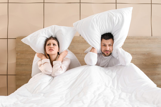 Young couple cannot sleep because of rowdy neighbours