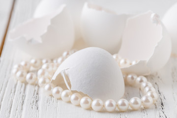 white pearl jewelry on a white egg