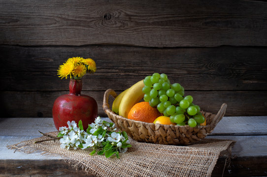 Still life from grape, bananas,orange and flowers