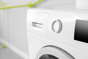 Modern washing machine in bathroom, closeup