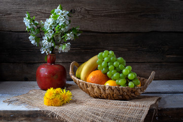 Still life from grape, bananas,orange and flowers