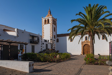 Fototapeta premium Central square with church tower in Betancuria village on Fuerteventura island in Spain. October 2019