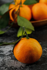 a plate with some tangerines on marble background