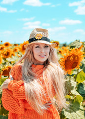 Beautiful woman in meadow with sunflowers.