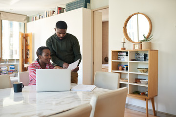 Young African American couple going over their household finances