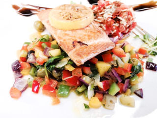 grilled salmon and lemon - french cuisine dish with tomato and salmon
