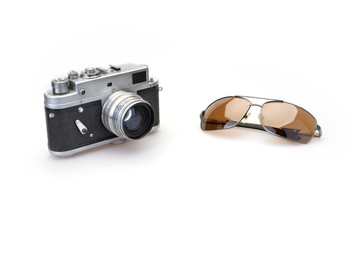 Old photo camera, sun glasses isolated