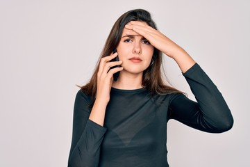 Young beautiful woman having a conversation talking on smartphone ove isolated background stressed with hand on head, shocked with shame and surprise face, angry and frustrated. Fear and upset