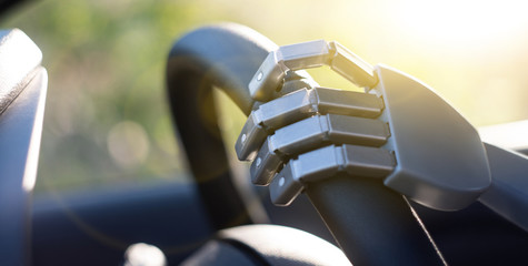 Robot arm on a steering wheel. Artificial intelligence drives a car. Autonomous vehicle concept.	