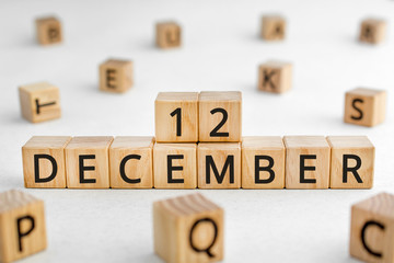 December 12 - from wooden blocks with letters, important date concept, white background random letters around