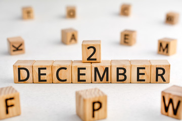 December 2 - from wooden blocks with letters, important date concept, white background random letters around