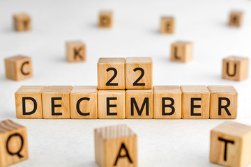 December 22 - from wooden blocks with letters, important date concept, white background random letters around