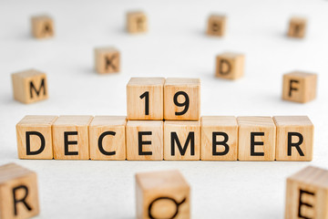 December 19 - from wooden blocks with letters, important date concept, white background random letters around