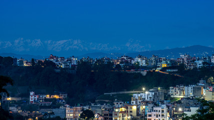 Naklejka premium Lights in the City with the Himalaya Mountains in the Background