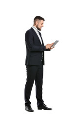 Young businessman with tablet computer on white background