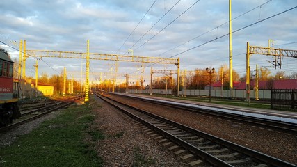 Obraz premium railway in spring at sunset in the countryside
