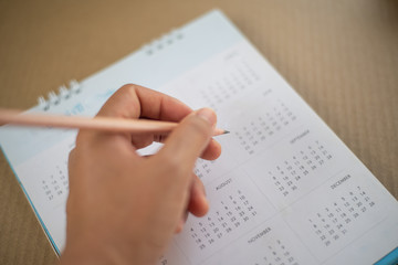 Close up hand with pencil in planning concept.