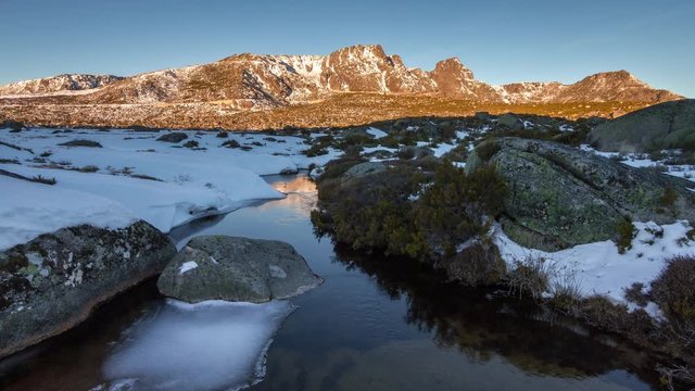 First Sun Lights of the morning touching the Mountain Range "Os C&acirc;ntaros" captured from the St Antonio Fields, in Serra da Estrela Natural Park, Portugal - Timelapse