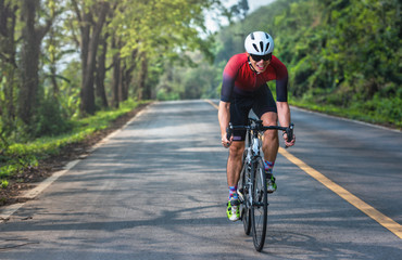 Fototapeta na wymiar Asian men are cycling road bike in the morning