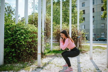 A beautiful young caucasian girl is exercising in nature