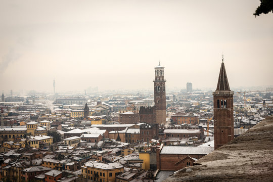 Aerial view of Verona downtown in winter with snow. Church of Santa Anastasia and medieval tower of Lamberti. UNESCO world heritage site. Veneto, Italy, Europe
