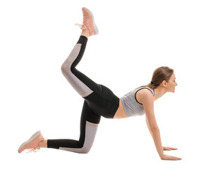 Sporty young woman training against white background