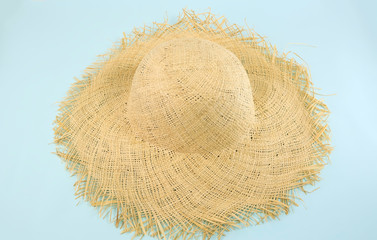 Straw hat on isolated blue background